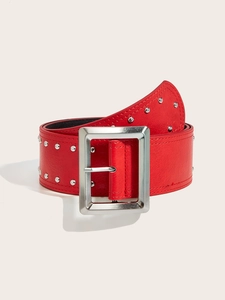 Macro shot of red punk leather belt with silver studs and a rectangular metal buckle