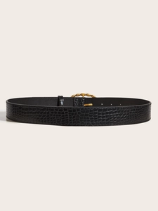 Detail of black crocodile texture belt featuring a vintage gold woven metal buckle
