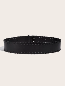 Detail of a vintage black leather belt with decorative whipstitch edges and silver buckle