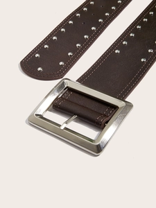 Macro shot of punk style brown leather belt with silver square buckle and metal rivets