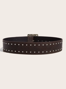 Detailed macro view of dark brown leather belt featuring double rows of silver rivets