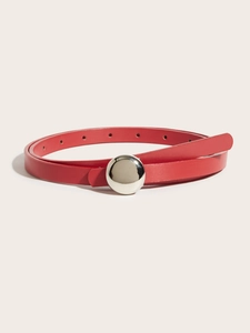 Macro detail of slim red belt showing smooth leather texture and round silver metal buckle