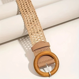 Bohemian khaki braided belt with a round wooden buckle on a minimalist white display