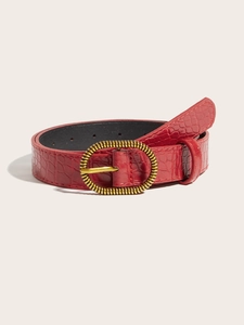 Detail of red crocodile texture belt with gold spiral buckle for women jeans
