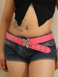 Close-up of pink Y2K belt with metal star eyelets and a large crystal star buckle