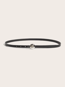 Close-up of minimalist black leather belt with a sleek silver ball buckle for women
