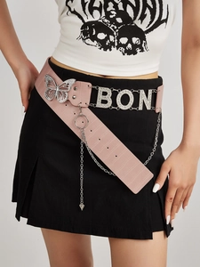 Close-up of pink faux crocodile leather belt with rhinestone butterfly and silver chains