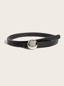 Detailed macro shot of slim black leather belt with silver spherical buckle and textured finish