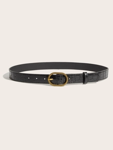Close-up of black crocodile embossed leather belt with a golden spiral oval metal buckle