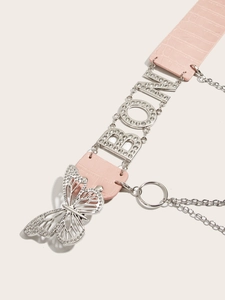 Close-up of pink faux-crocodile belt featuring a silver butterfly pendant and metal letters
