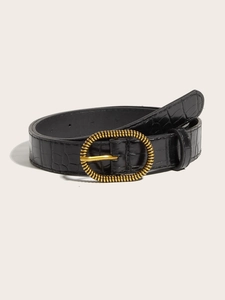 Detailed macro view of black crocodile pattern leather belt with vintage golden oval buckle