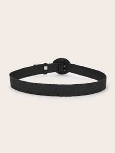 Detail view of black woven belt with matching round buckle and bohemian texture