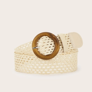Detail of woven straw belt featuring a round wooden buckle and bohemian beige texture