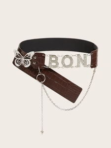 Detail of dark brown crocodile embossed belt with silver butterfly and BON metal charms