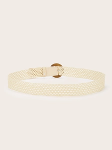Detail of woven straw belt with a round wooden buckle and beige braided texture