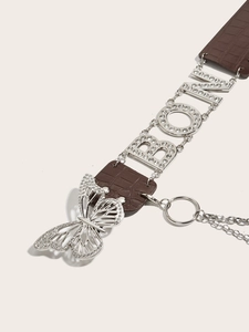 Detail of vintage belt featuring crocodile texture leather and rhinestone butterfly buckle