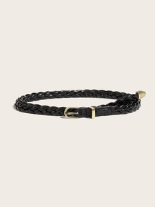 Detailed macro view of black braided thin belt with a matte gold D-ring buckle