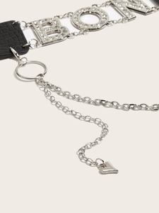 Detail of silver butterfly buckle belt with sparkling rhinestones and black leather texture