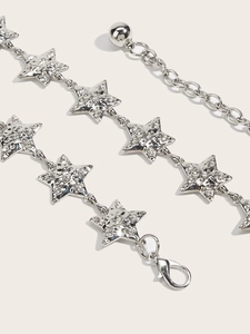 Close-up of silver metal star chain belt featuring rhinestone inlay and lobster clasp