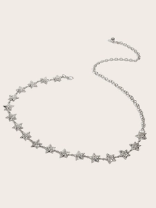 Detailed close-up of a silver star-shaped metal waist chain belt with sparkling rhinestones