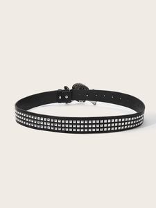 Close-up of black punk belt featuring three rows of silver pyramid studs and a metal buckle