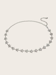 Macro view of silver star chain belt with sparkling rhinestones and lobster clasp closure