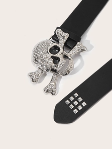 Close-up of punk leather belt featuring rhinestone skull buckle and silver square studs