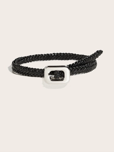 Détail de la texture tressée complexe d'une ceinture noire avec une boucle argentée polie