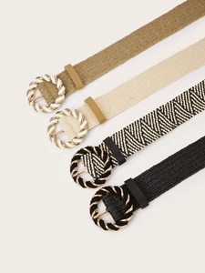 Detail of bohemian braided belts with round buckles in khaki, beige, and black