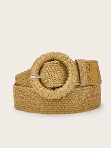Detail of woven straw belt with round buckle and reinforced brown leather tip