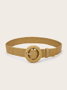 Close-up of woven straw belt with a large round buckle in bohemian khaki finish