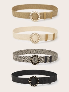 Detail of four woven belts with round textured metal buckles in bohemian retro style