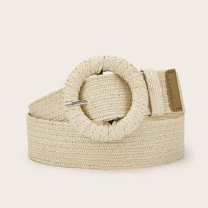 Close-up detail of woven straw belt texture with round buckle and metallic pin