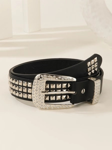 Detail of black leather punk belt with square studs and rhinestone encrusted buckle
