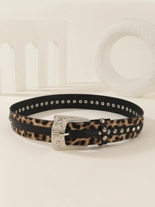 Detail of western leopard print belt with silver studs and engraved floral buckle