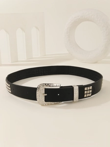 Detail of a black leather punk belt with silver rhinestone buckle and metal studs