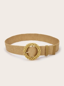 Close-up of bohemian elastic woven belt with a decorative round wooden bead buckle detail