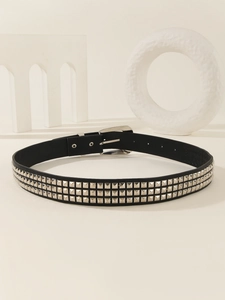 Detail of black punk leather belt with double rows of silver square metal rivets and buckle