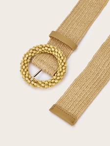 Detail of woven straw belt with a round wooden bead buckle and faux leather accents