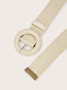 Close-up of beige woven belt with a round buckle and fine texture detail