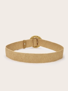 Close-up of woven stretch belt with round buckle in khaki bohemian style for dresses
