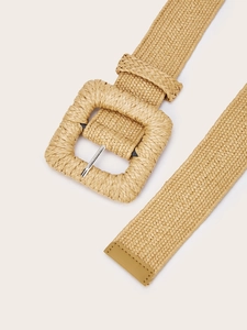 Detail shot of woven straw belt with textured square buckle and silver metal prong