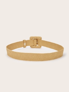 Close-up of woven straw belt texture and square buckle for bohemian summer dresses