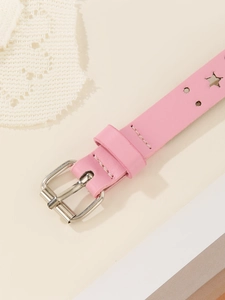 Detailed close-up of pink leather star-perforated belt with silver metal pin buckle