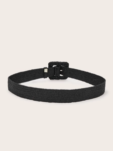 Detailed close-up of a black woven belt featuring a square buckle with straw-like texture