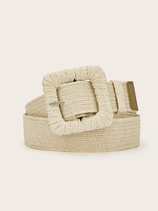 Detail of beige woven belt with large square raffia buckle and dark tan leather trim end