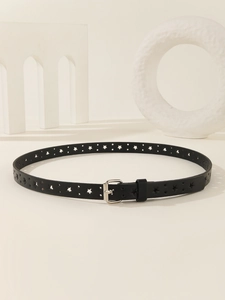 Macro detail of black leather skinny belt with star cutouts and silver pin buckle