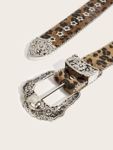 Detail of leopard print faux calf hair belt with ornate floral carved silver buckle