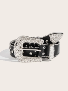 Detail of the vintage belt buckle with silver floral engravings and clear rhinestones