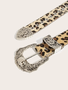 Detail of leopard print belt with silver floral buckle and star-shaped eyelets